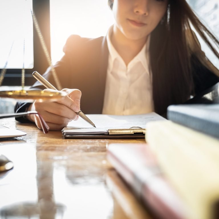 Close up lawyer businessman working or reading lawbook in office workplace for consultant lawyer concept.